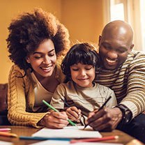 Black parents helping son with homework